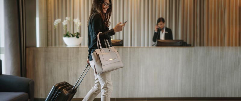 Business woman on a work trip  walking in a hotel lobby 