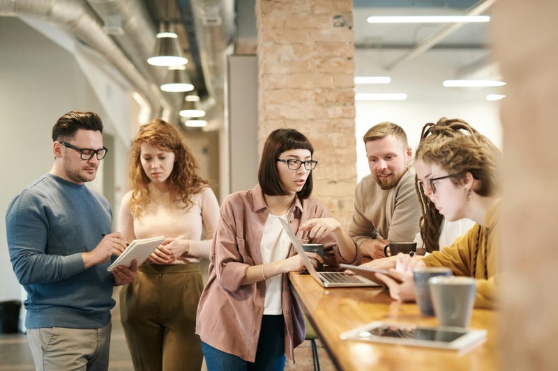 Group of employees discussing at the office: Are finance jobs at risk of automation?