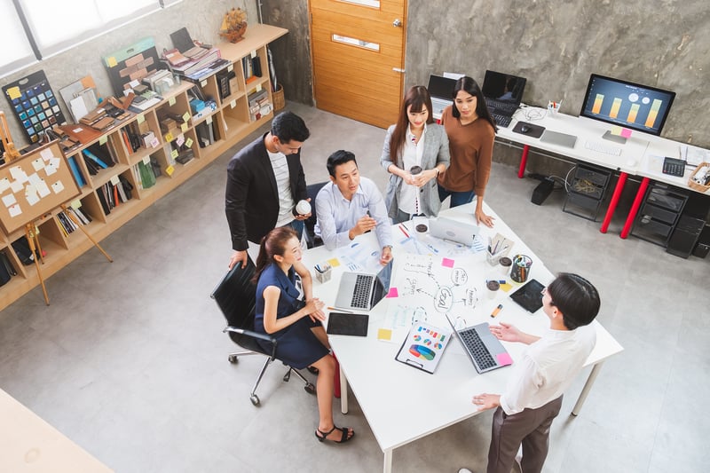 Office employees discussing at a table