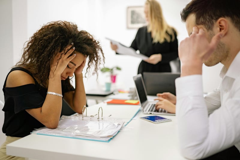 Woman at a table frustrated with manual receipts for travel and expense management