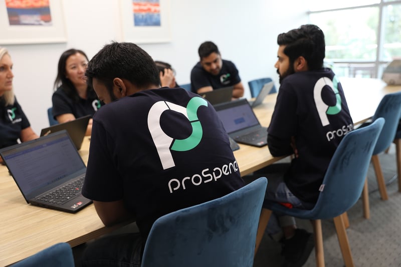 Employees at the table with automation in the workplace