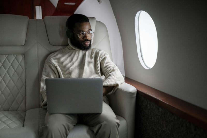 Man on an airplane, travelling for work