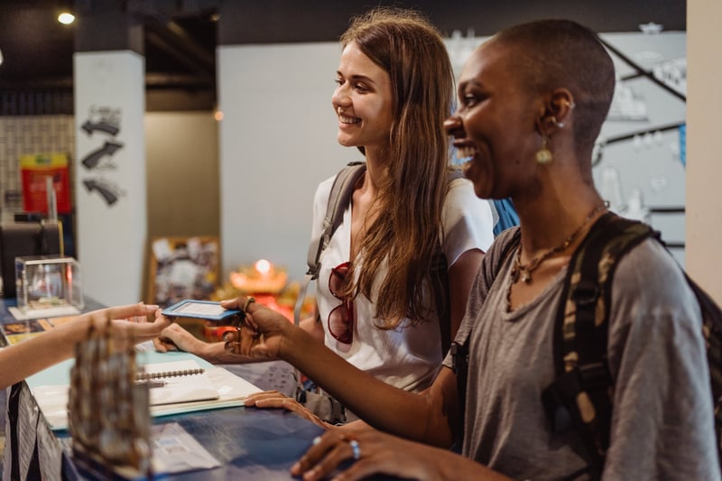 Two hotel guests checking in with automation in the hospitality industry