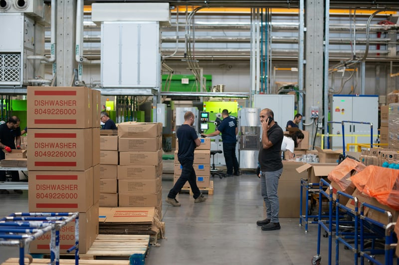 Factory workers handling finance in the manufacturing industry