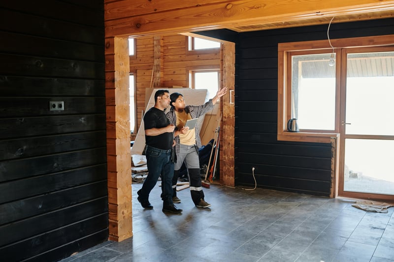 Two people discussing financial management in construction