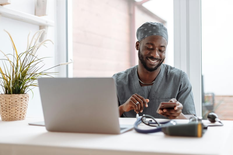 Man in scrubs working on healthcare finance management