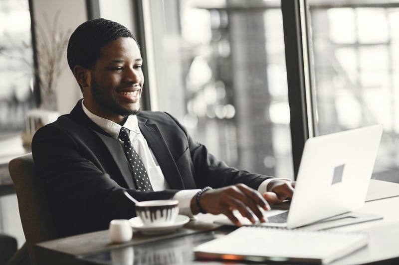 a man in a desk preparing his travel expense report